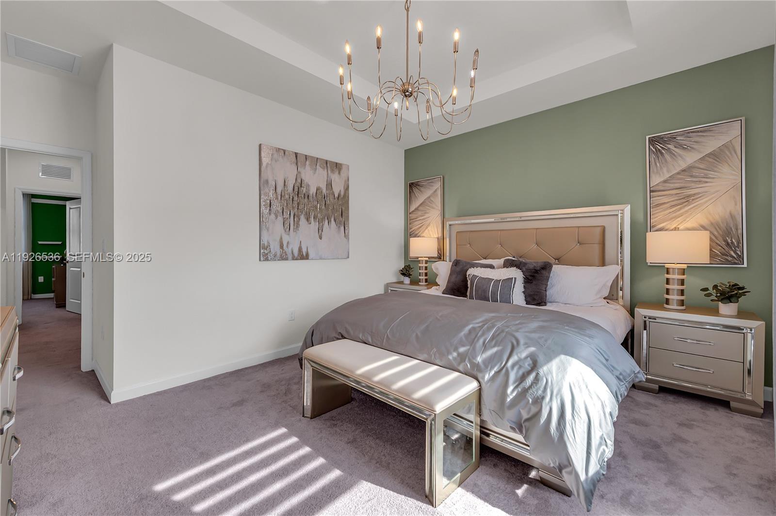 12980 Southwest 233rd Terrace Homestead, FL 33032 - Photo 18 of 28 a bedroom with a bed and a chandelier