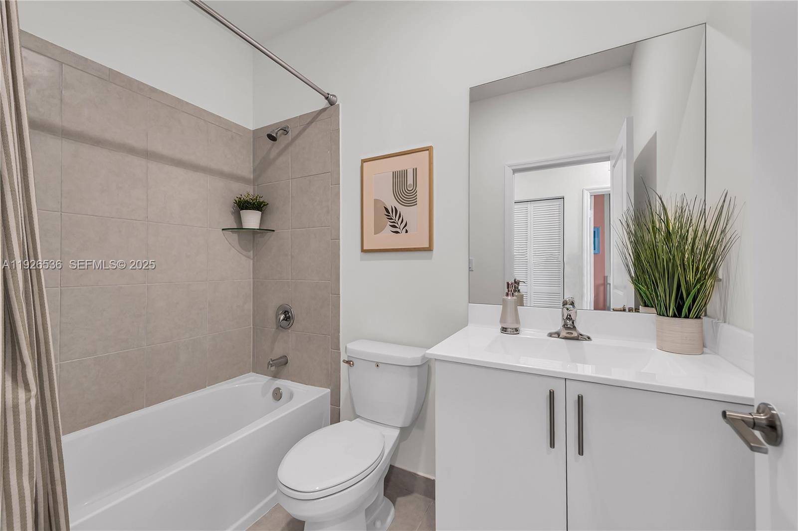 12980 Southwest 233rd Terrace Homestead, FL 33032 - Photo 23 of 28 a bathroom with a sink a toilet a tub and shower