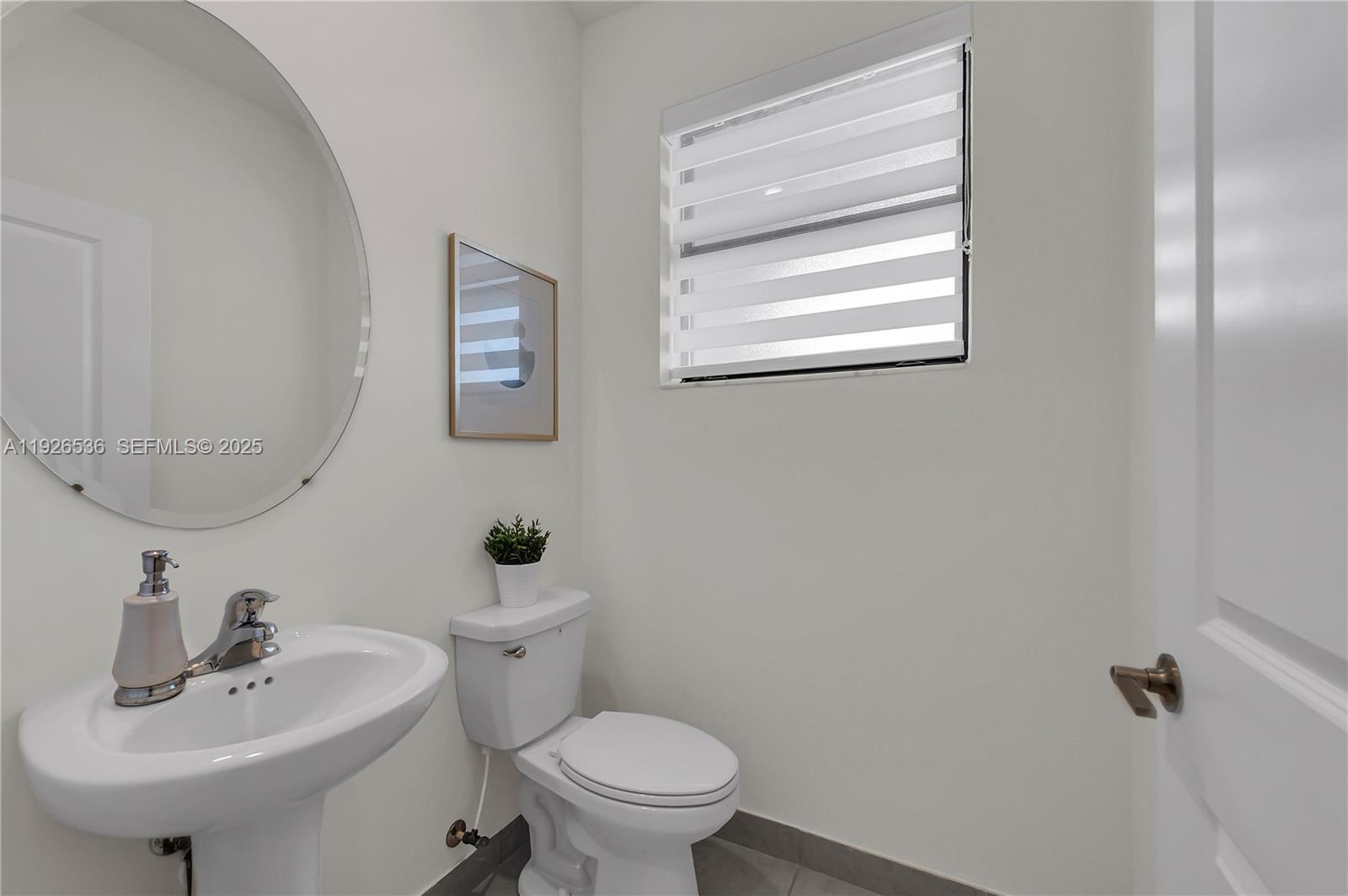 12980 Southwest 233rd Terrace Homestead, FL 33032 - Photo 6 of 28 a bathroom with a sink a mirror and a toilet