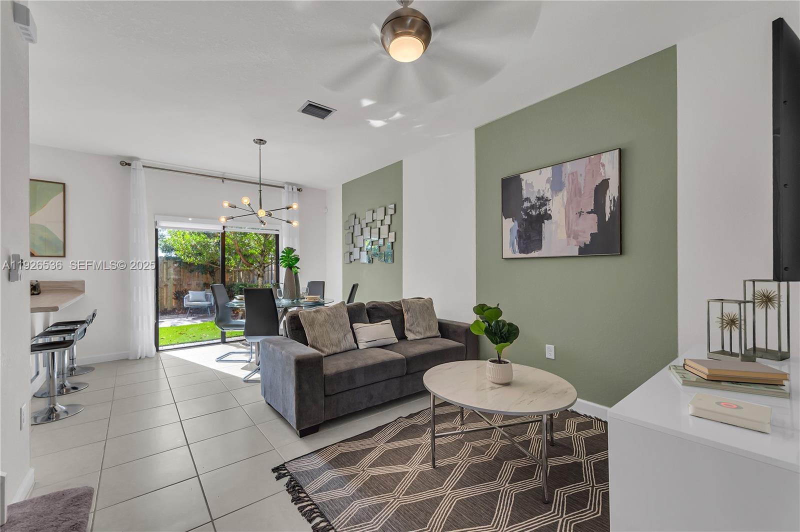 12980 Southwest 233rd Terrace Homestead, FL 33032 - Photo 8 of 28 a living room with furniture and a open kitchen view