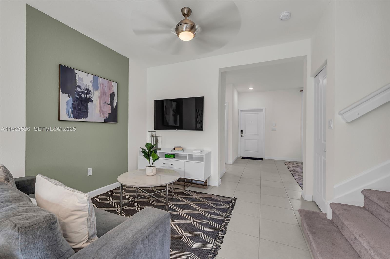 12980 Southwest 233rd Terrace Homestead, FL 33032 - Photo 9 of 28 a living room with furniture and a flat screen tv