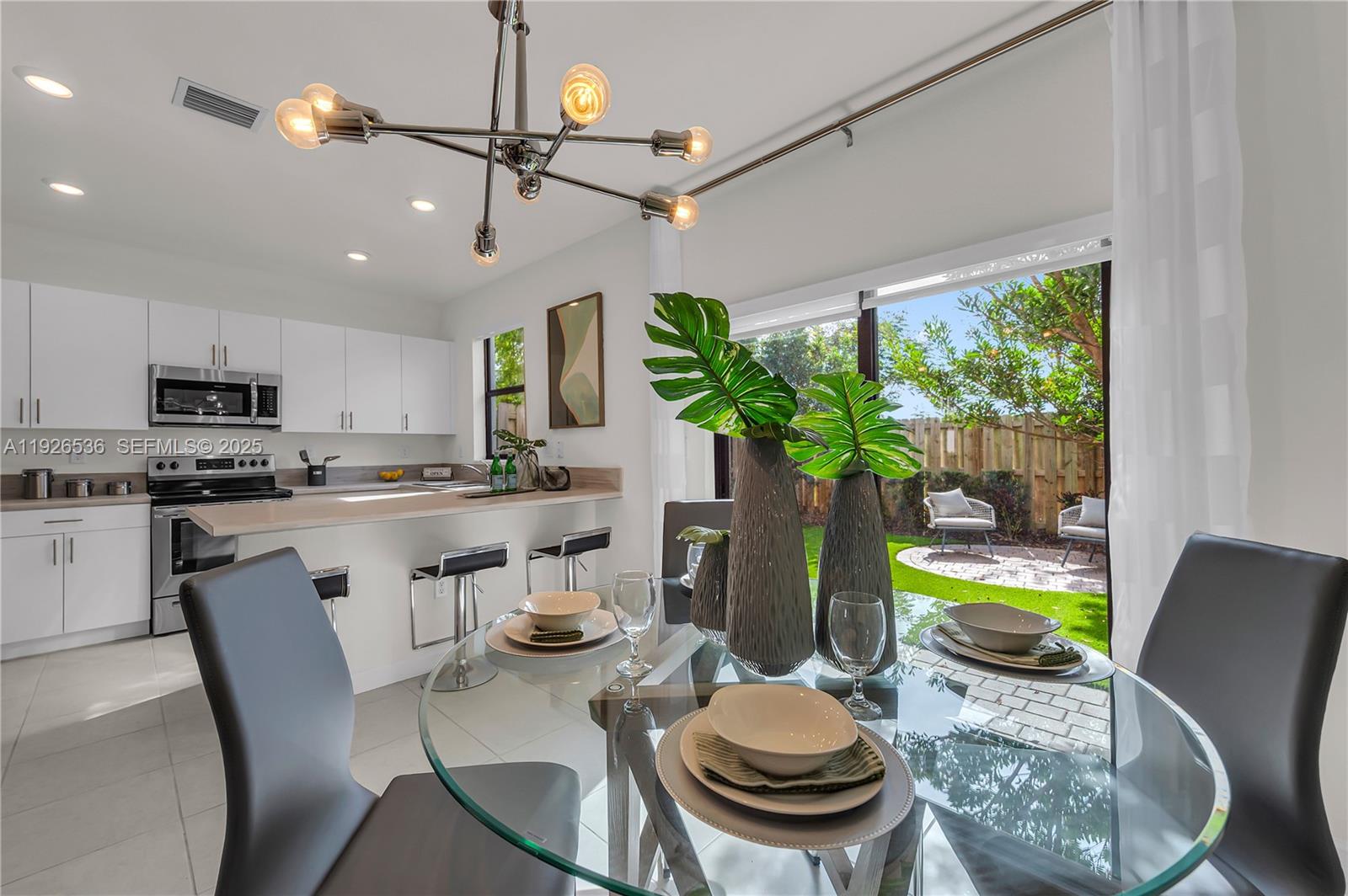 12980 Southwest 233rd Terrace Homestead, FL 33032 - Photo 10 of 28 a view of a dining room with furniture a potted plant and wooden floor