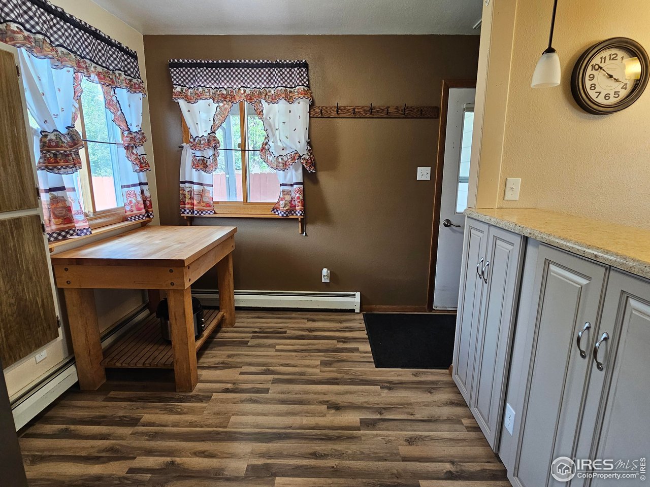 570 California Street Sterling, CO 80751 - Photo 13 of 41 a view of a hallway with wooden floor and a window