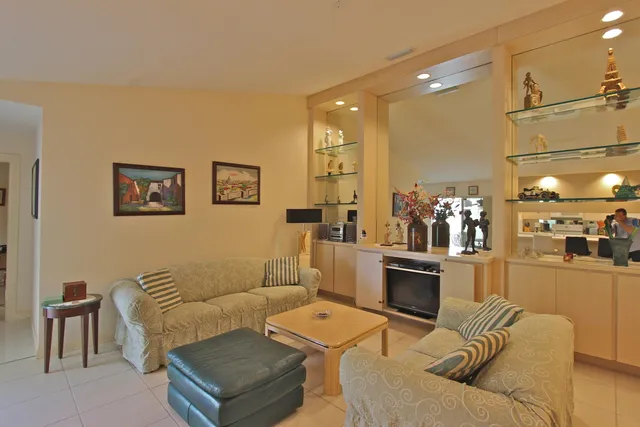 a living room with furniture and a kitchen view