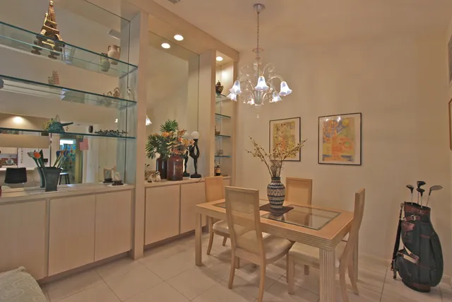 a view of a dining room with furniture and chandelier