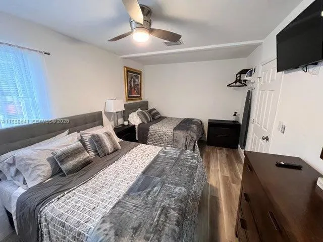 a bed room with two bed and a flat screen tv