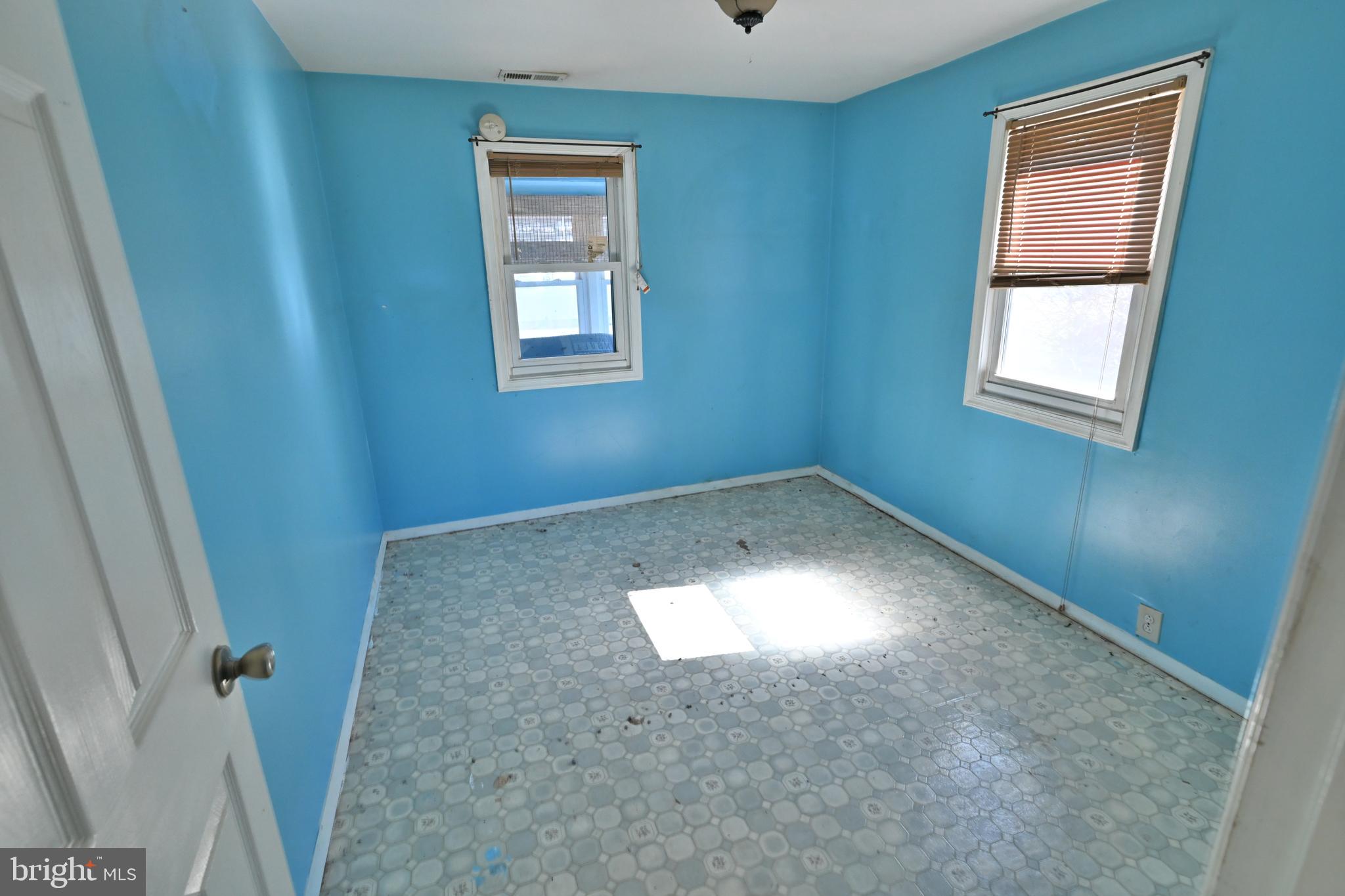 109 Hughes Shore Road Baltimore, MD 21220 - Photo 24 of 43 wooden floor in an empty room with a window