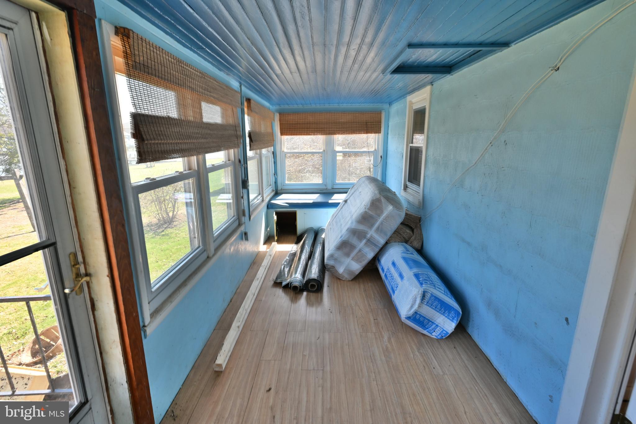 109 Hughes Shore Road Baltimore, MD 21220 - Photo 26 of 43 a view of balcony with a large window and wooden floor