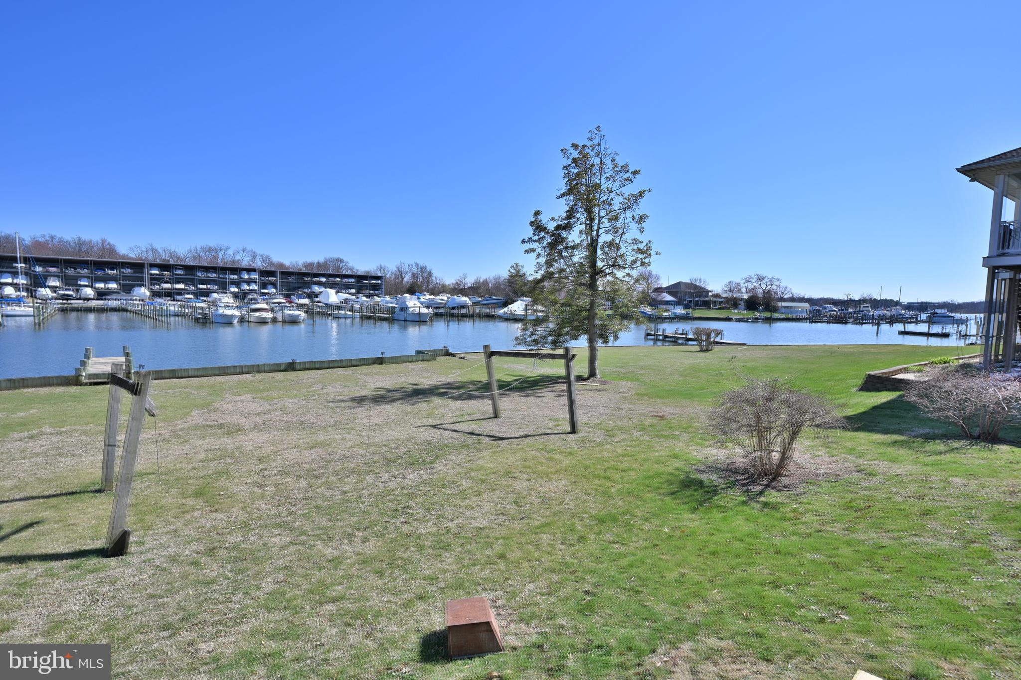 109 Hughes Shore Road Baltimore, MD 21220 - Photo 30 of 43 a view of a lake with a yard and large trees