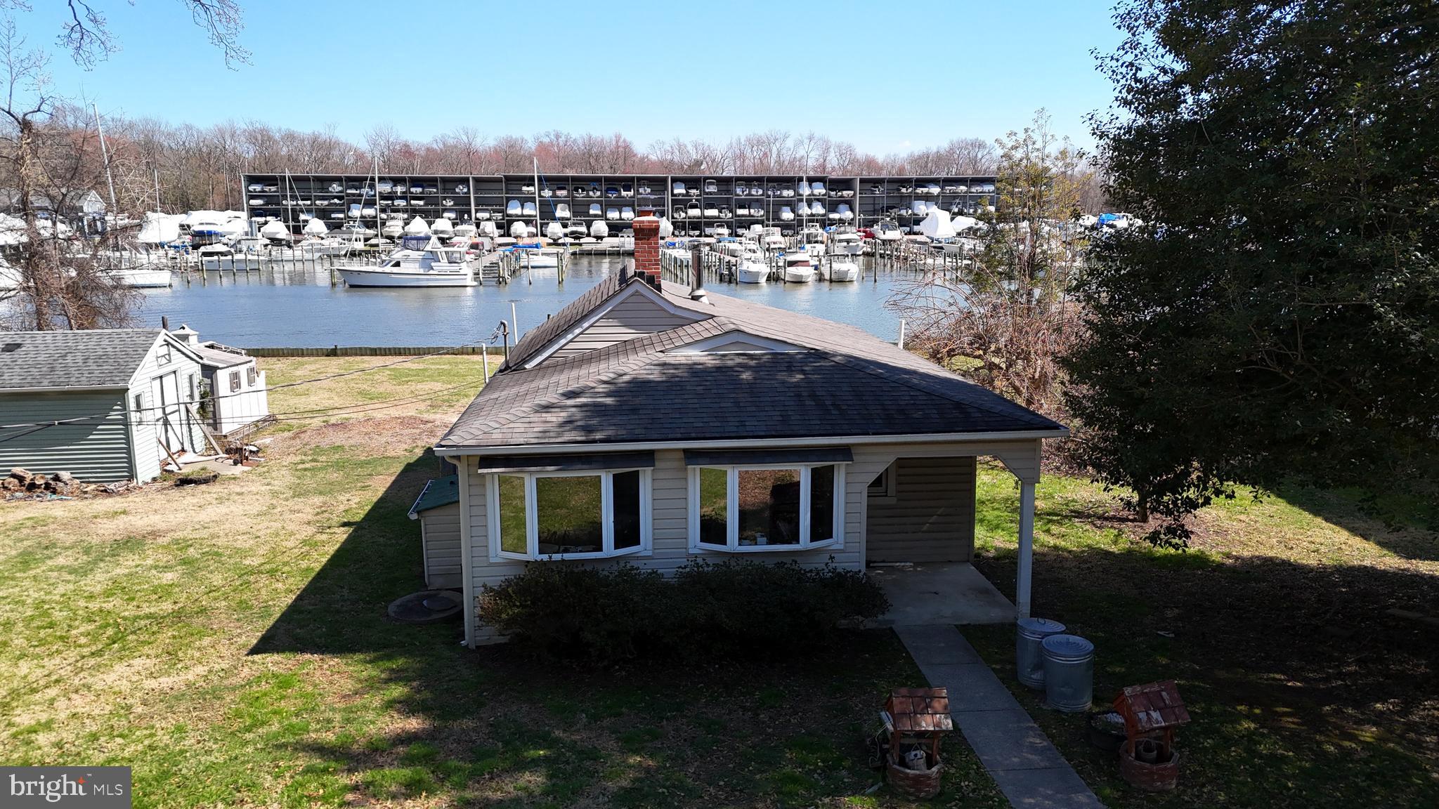 109 Hughes Shore Road Baltimore, MD 21220 - Photo 3 of 43 a house with trees in the background