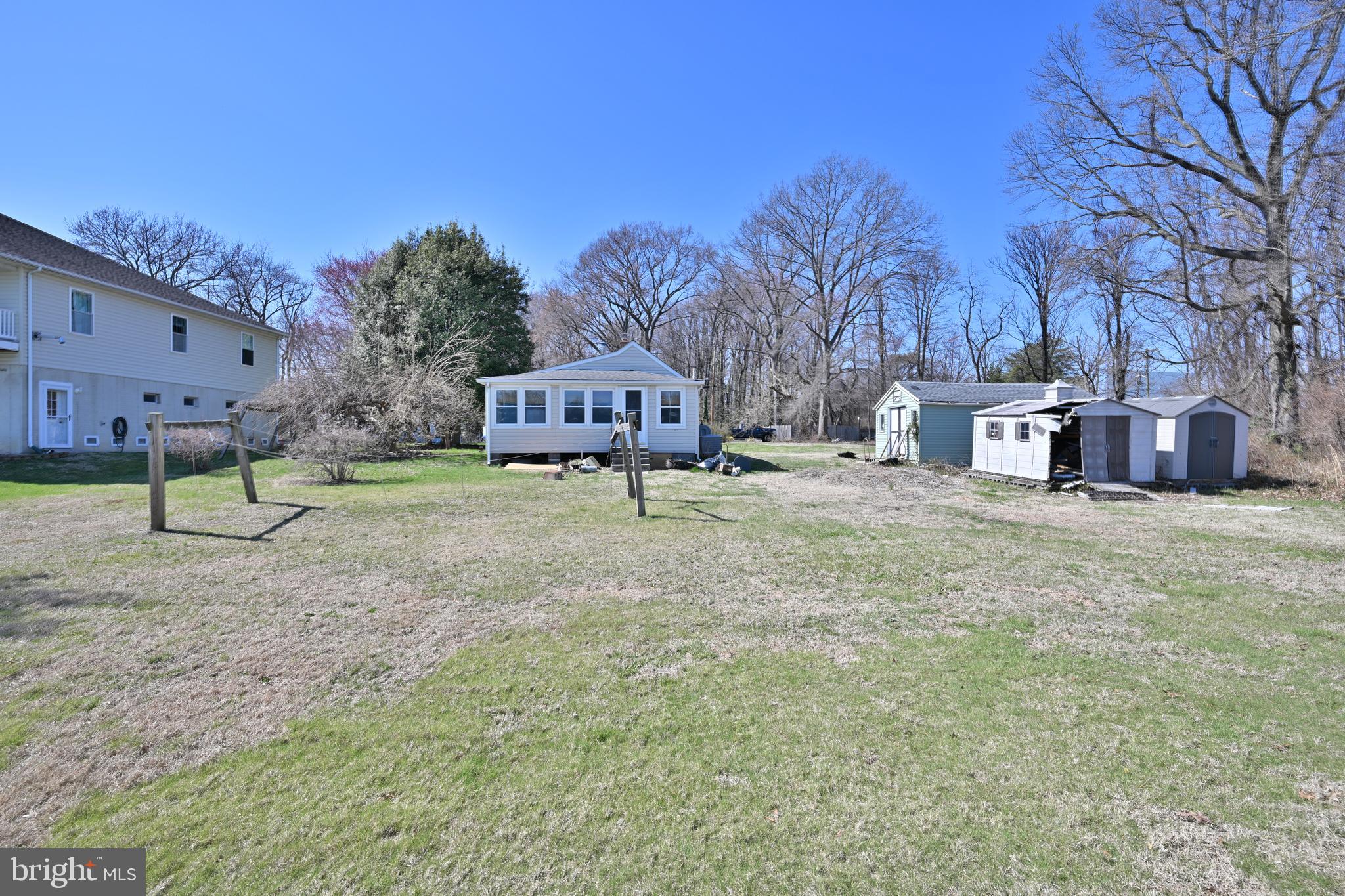 109 Hughes Shore Road Baltimore, MD 21220 - Photo 37 of 43 a view of a yard with a house and trees in the background