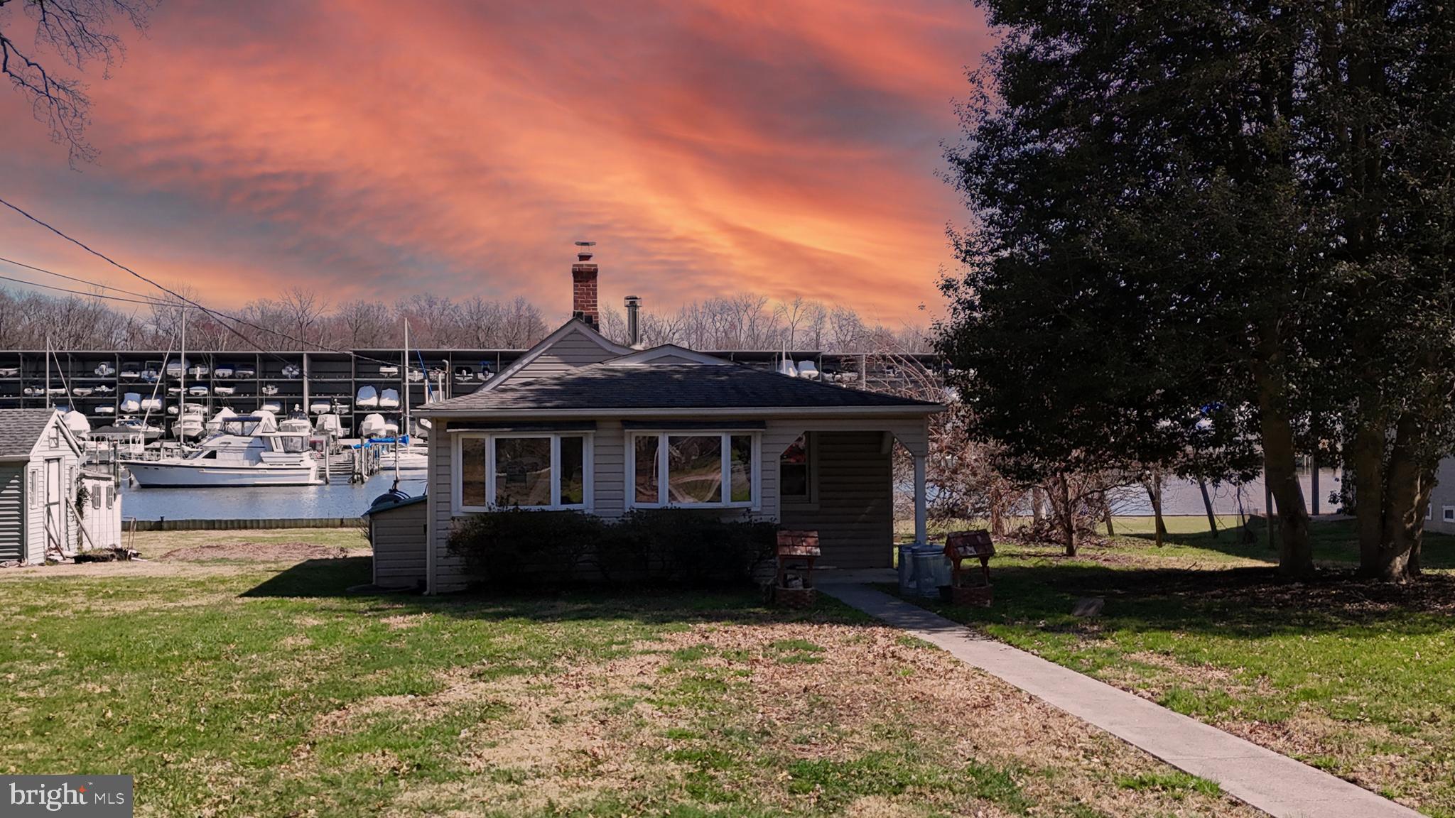 109 Hughes Shore Road Baltimore, MD 21220 - Photo 41 of 43 front view of a house with a yard