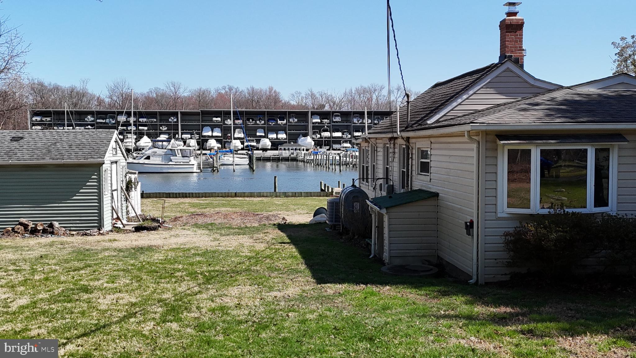 109 Hughes Shore Road Baltimore, MD 21220 - Photo 5 of 43 a view of a house with backyard