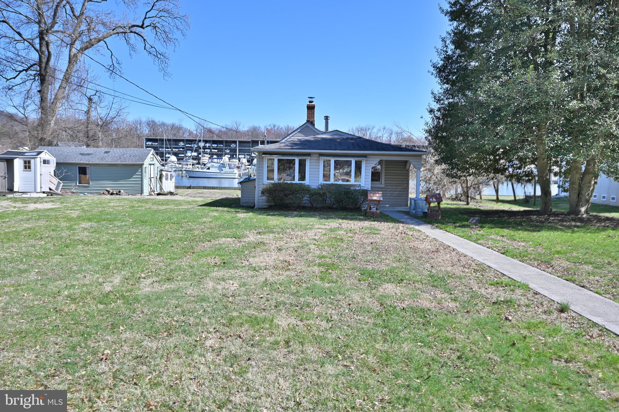 109 Hughes Shore Road Baltimore, MD 21220 - Photo 6 of 43 a view of a house with a yard
