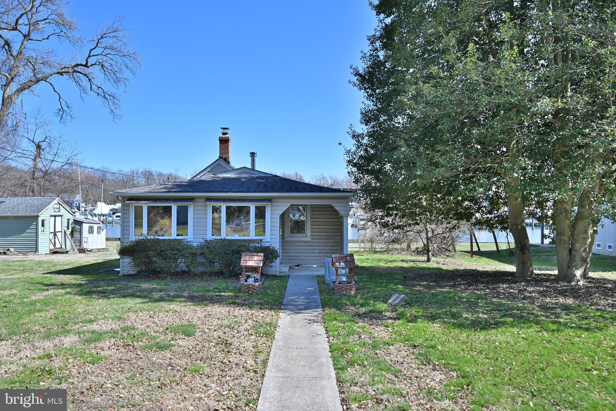 109 Hughes Shore Road Baltimore, MD 21220 - Photo 7 of 43 a front view of a house with garden