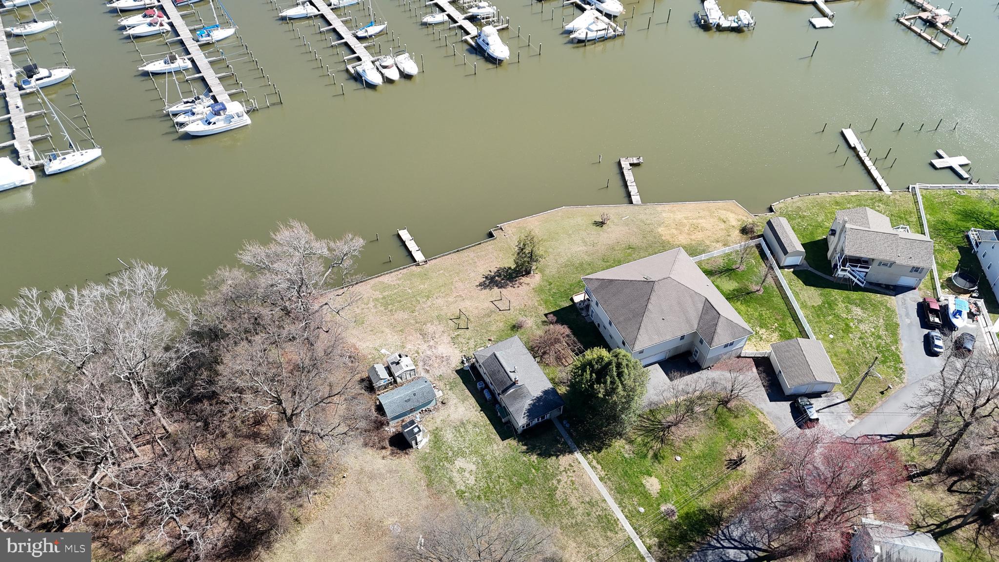 109 Hughes Shore Road Baltimore, MD 21220 - Photo 9 of 43 a bed sitting in a bedroom next to a chandelier