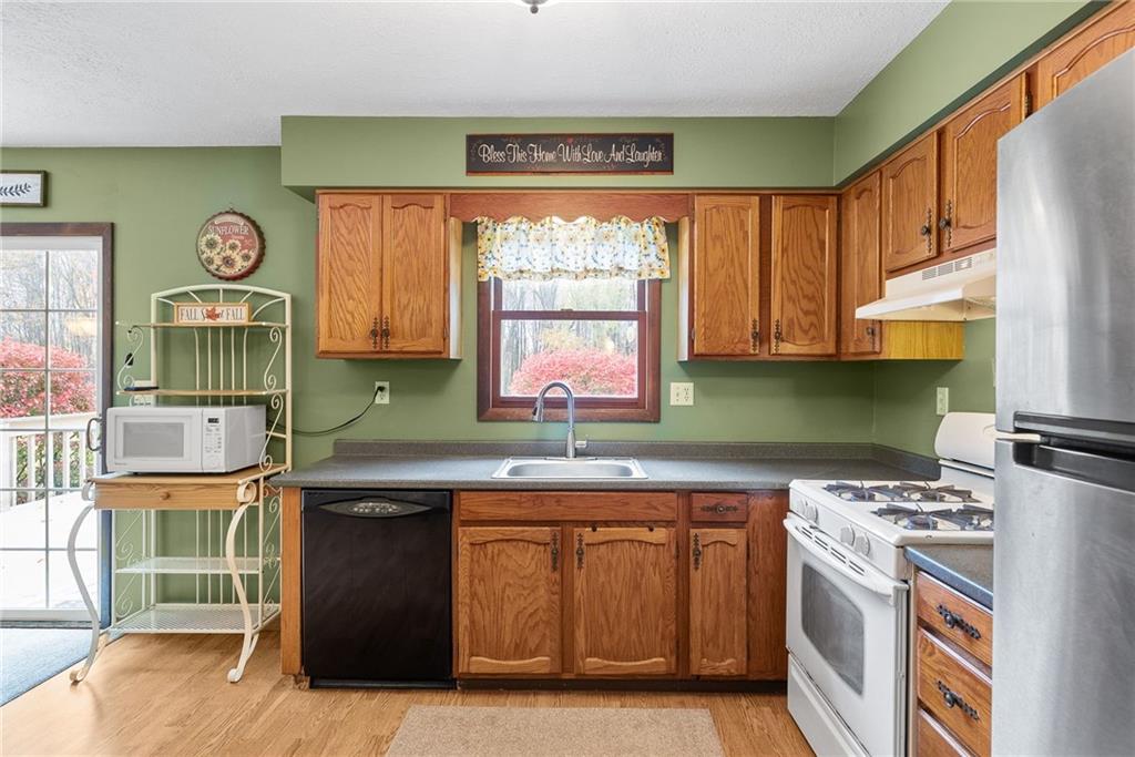 1010 Bonniebrook Road Butler, PA 16002 - Photo 14 of 48 a kitchen with a stove a sink and a refrigerator