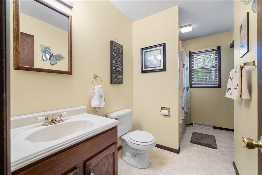 1010 Bonniebrook Road Butler, PA 16002 - Photo 19 of 48 a bathroom with a toilet a sink and mirror