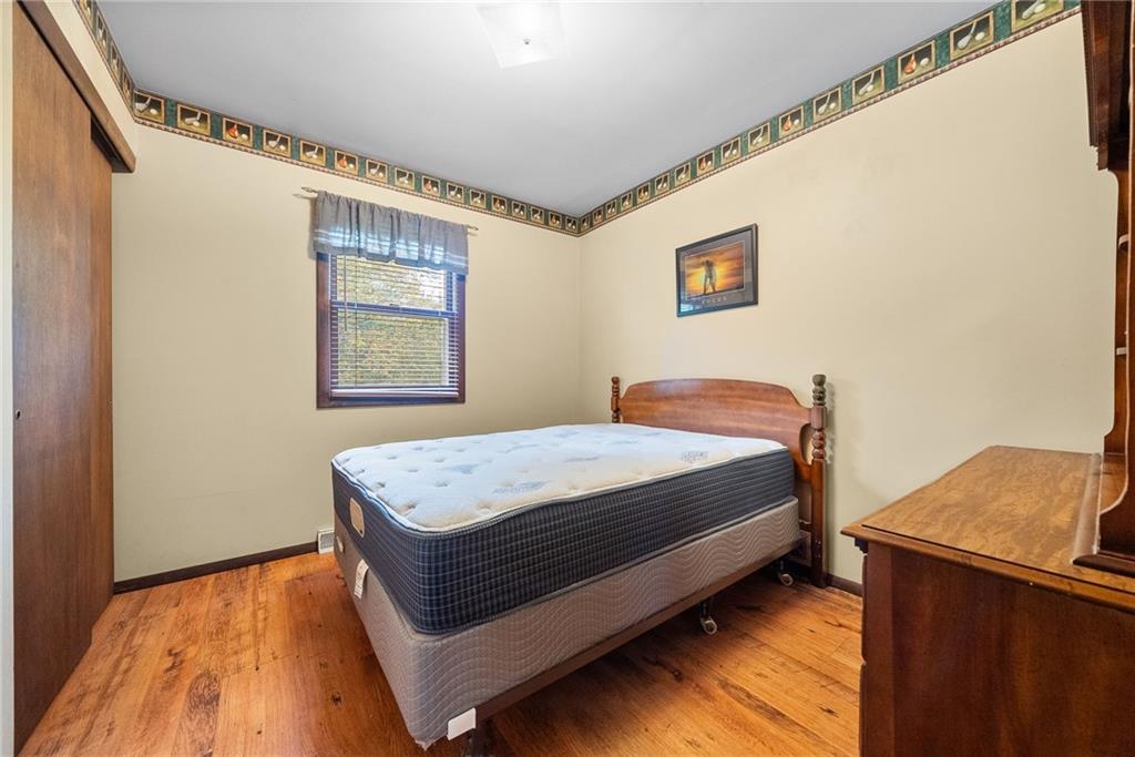 1010 Bonniebrook Road Butler, PA 16002 - Photo 21 of 48 a bedroom with a bed and wooden floor