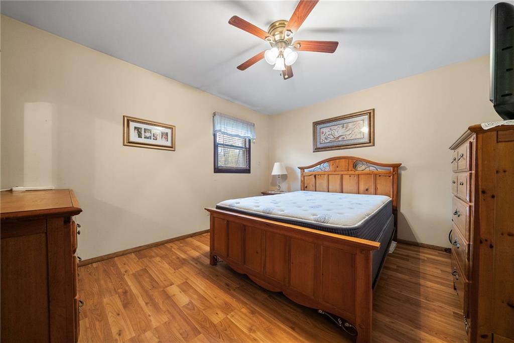 1010 Bonniebrook Road Butler, PA 16002 - Photo 25 of 48 a bedroom with a bed and a chandelier