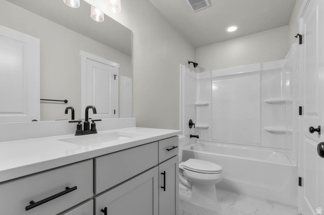 1567 North 3250 West Provo, UT 84601 - Photo 18 of 22 Bathroom vanity featuring light gray cabinetry with black hardware, a white countertop, and an undermount sink with a black faucet