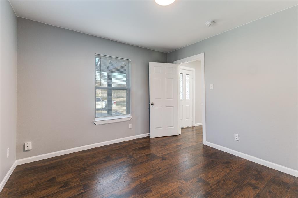 4010 Copeland Street Dallas, TX 75210 - Photo 17 of 23 a view of an empty room with wooden floor and a window