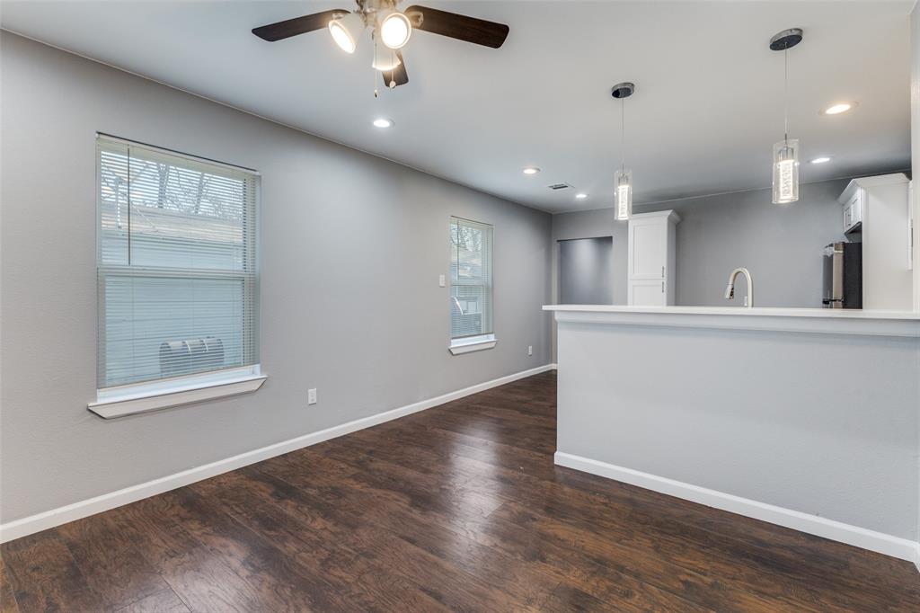 4010 Copeland Street Dallas, TX 75210 - Photo 5 of 23 a view of an empty room with a chandelier fan and fire place