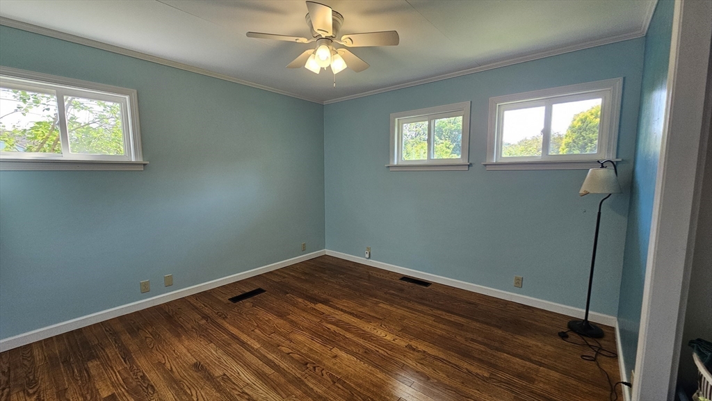 298 Ryan Road Northampton, MA 01062 - Photo 13 of 28 an empty room with wooden floor fan and windows
