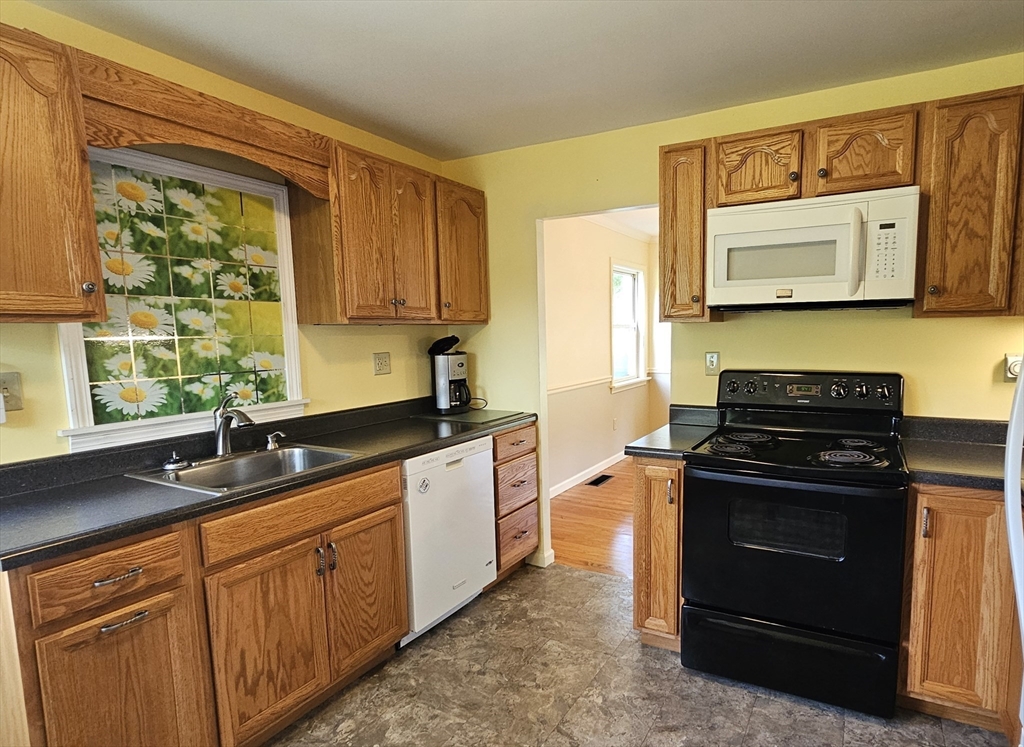298 Ryan Road Northampton, MA 01062 - Photo 6 of 28 a kitchen with a stove a sink and a microwave