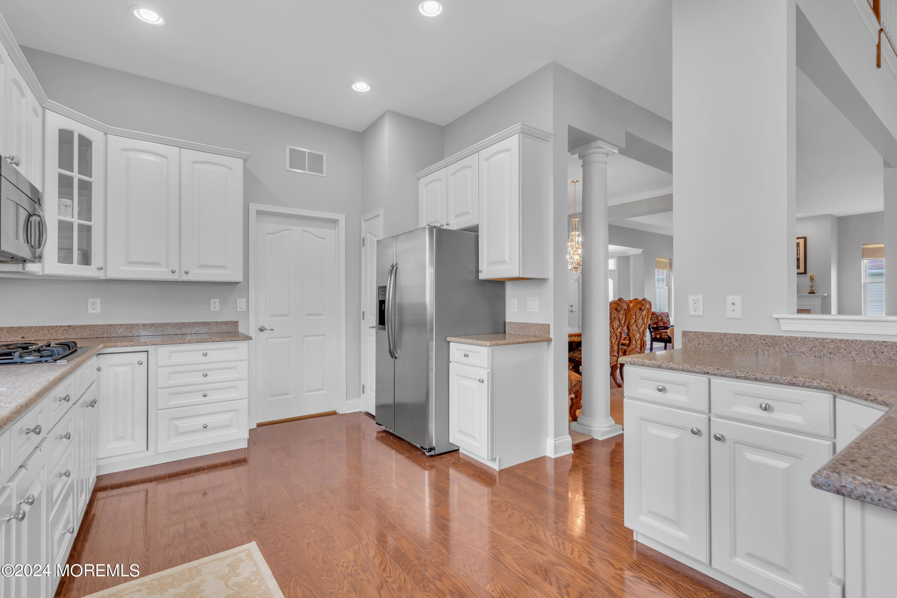 49 Eagleswood Drive Waretown, NJ 08758 - Photo 23 of 51 a kitchen with white cabinets and stainless steel appliances