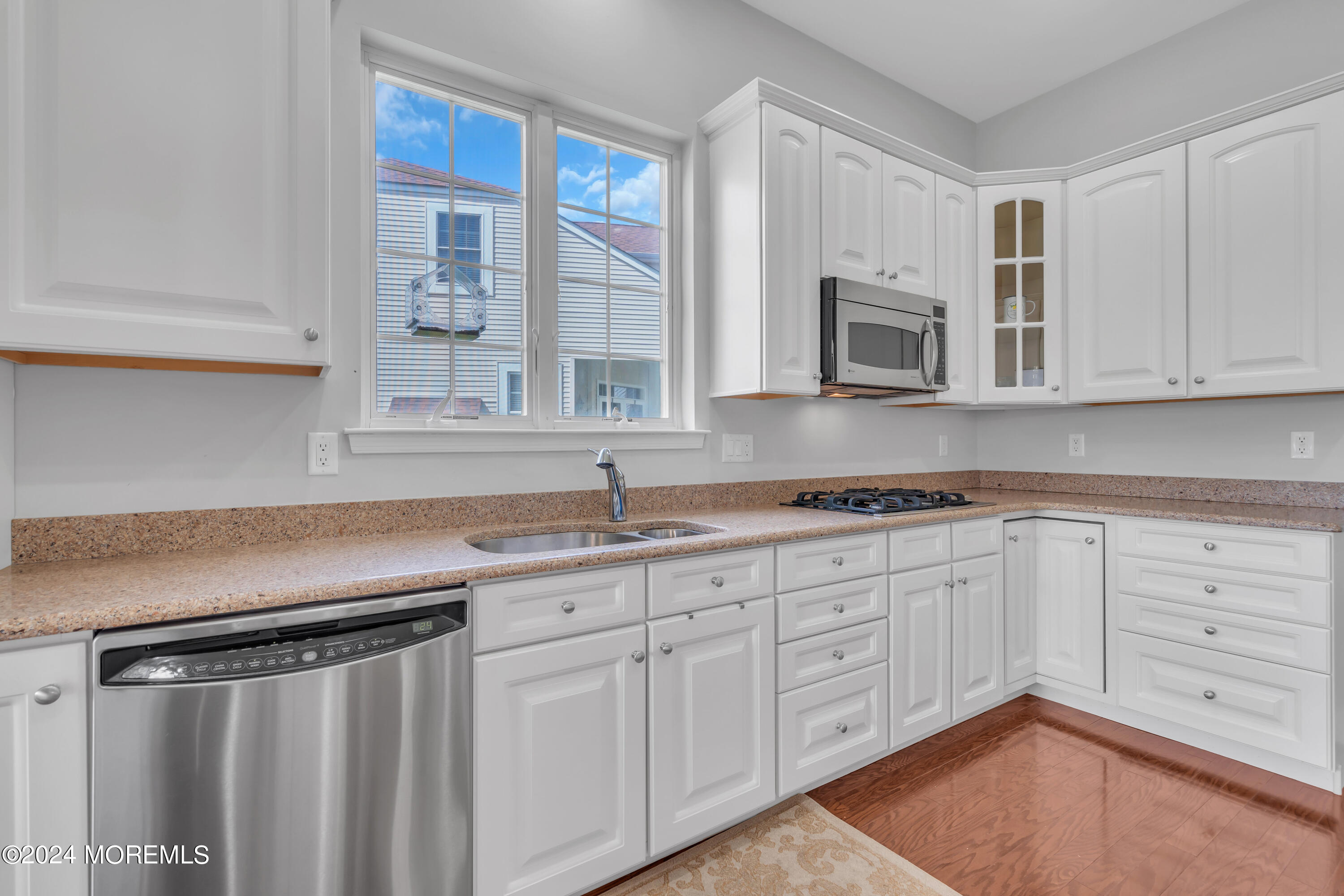 49 Eagleswood Drive Waretown, NJ 08758 - Photo 24 of 51 a kitchen with granite countertop a sink stainless steel appliances white cabinets and a window