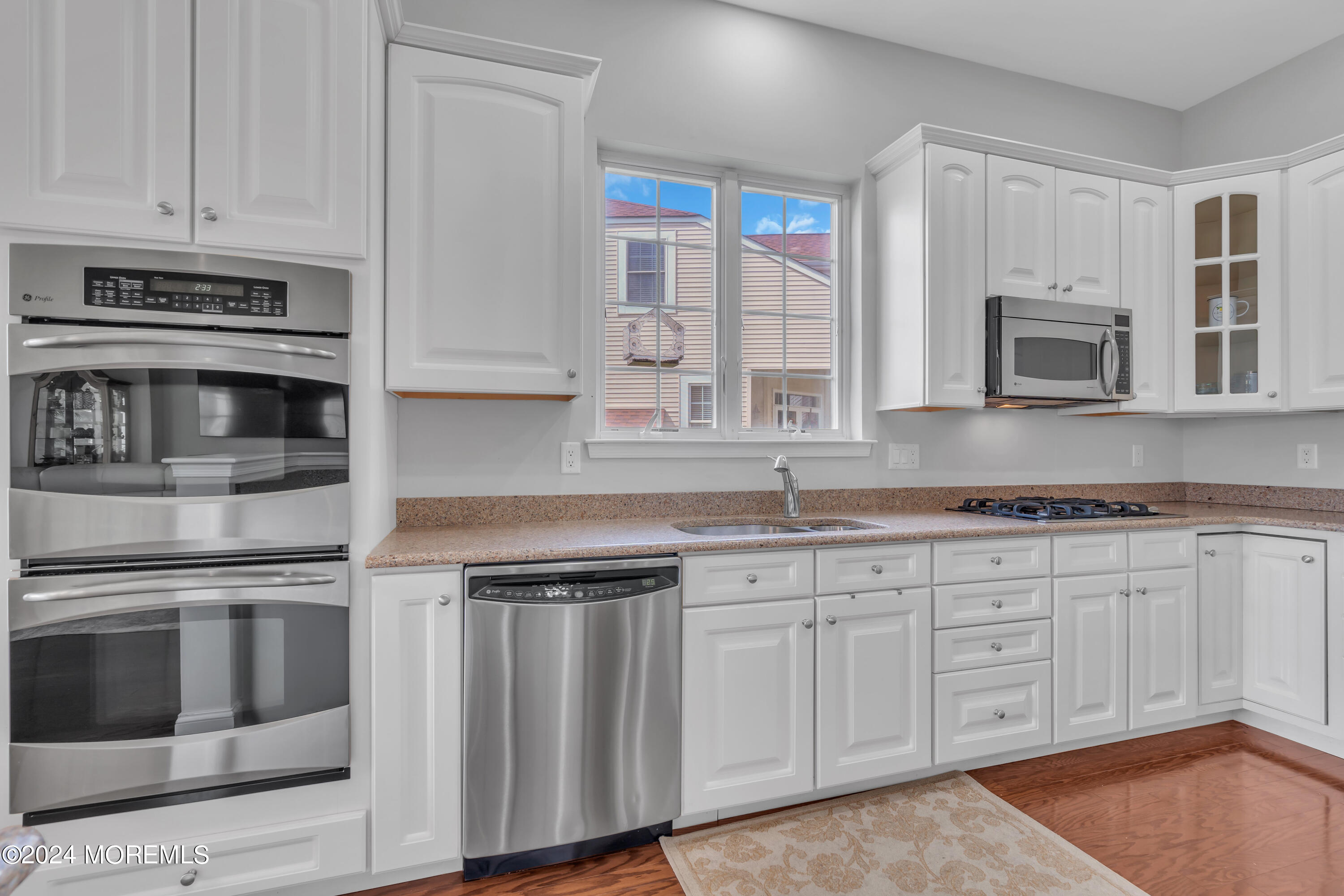 49 Eagleswood Drive Waretown, NJ 08758 - Photo 25 of 51 a kitchen with granite countertop white cabinets stainless steel appliances and a sink