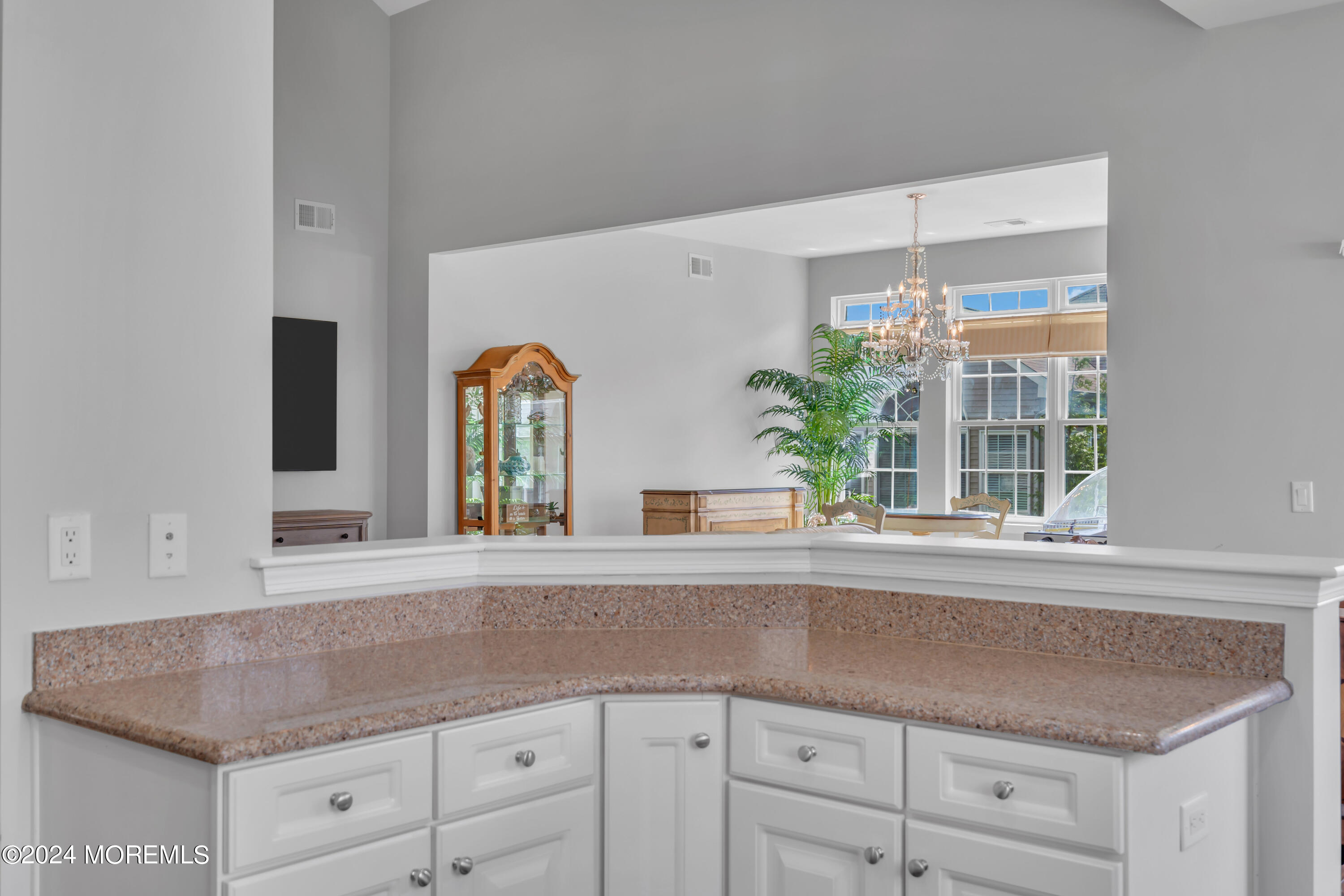 49 Eagleswood Drive Waretown, NJ 08758 - Photo 29 of 51 a kitchen with a granite countertop sink window and white cabinets