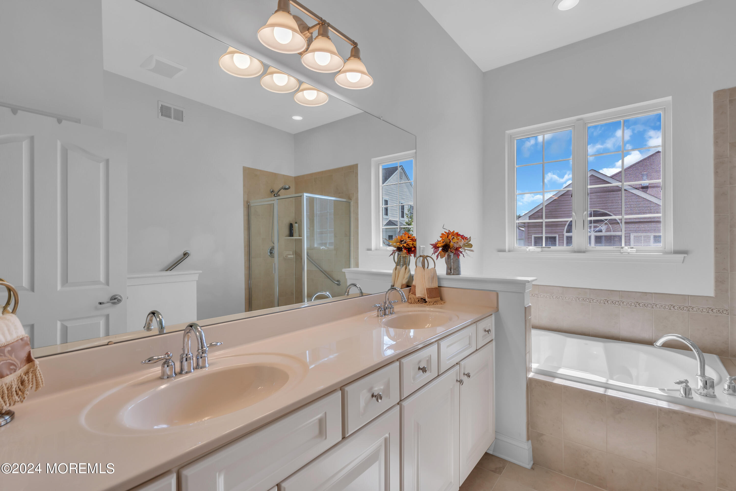 49 Eagleswood Drive Waretown, NJ 08758 - Photo 33 of 51 a bathroom with double vanity sinks a vanity a lamp and a mirror