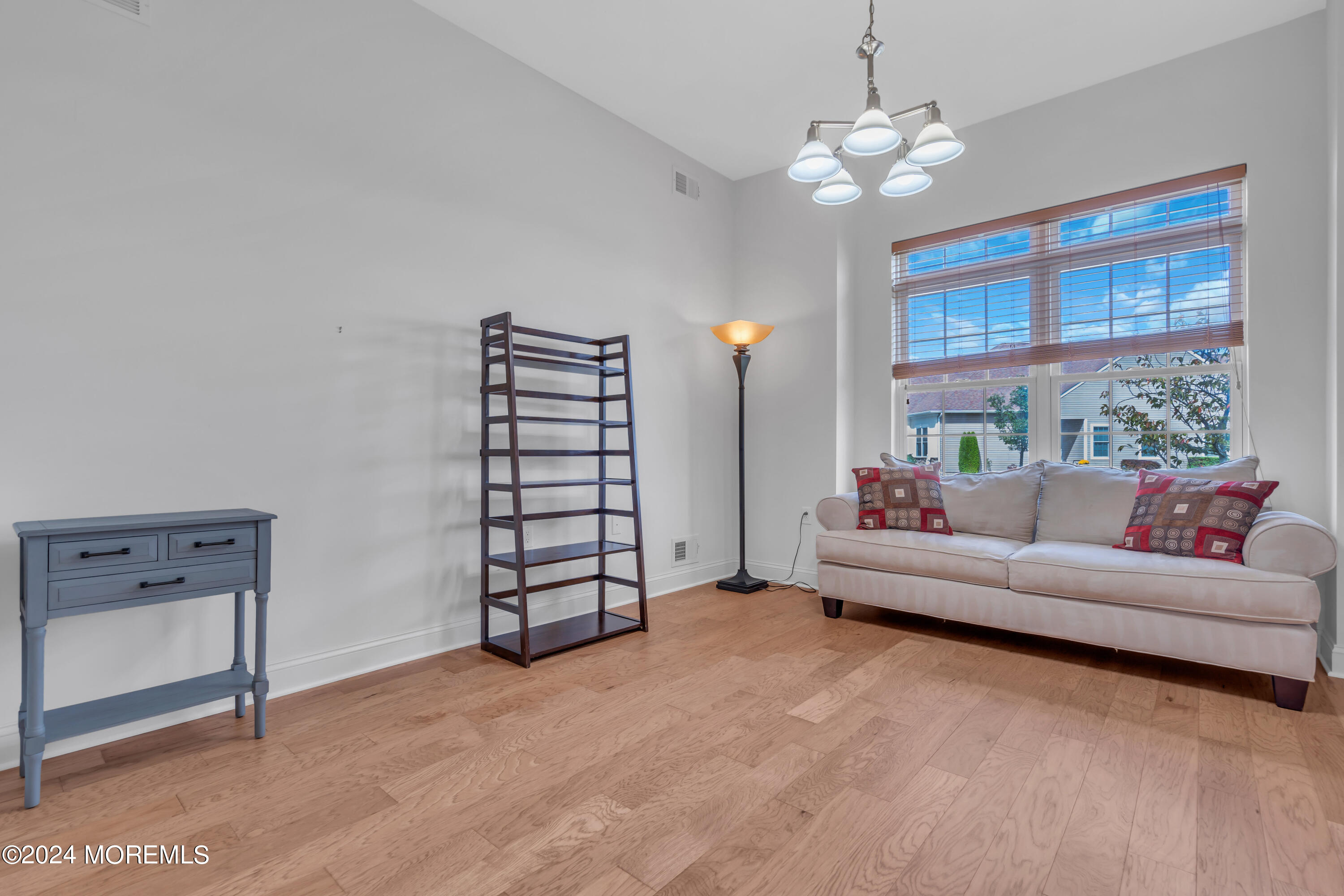 49 Eagleswood Drive Waretown, NJ 08758 - Photo 35 of 51 a living room with furniture and a chandelier
