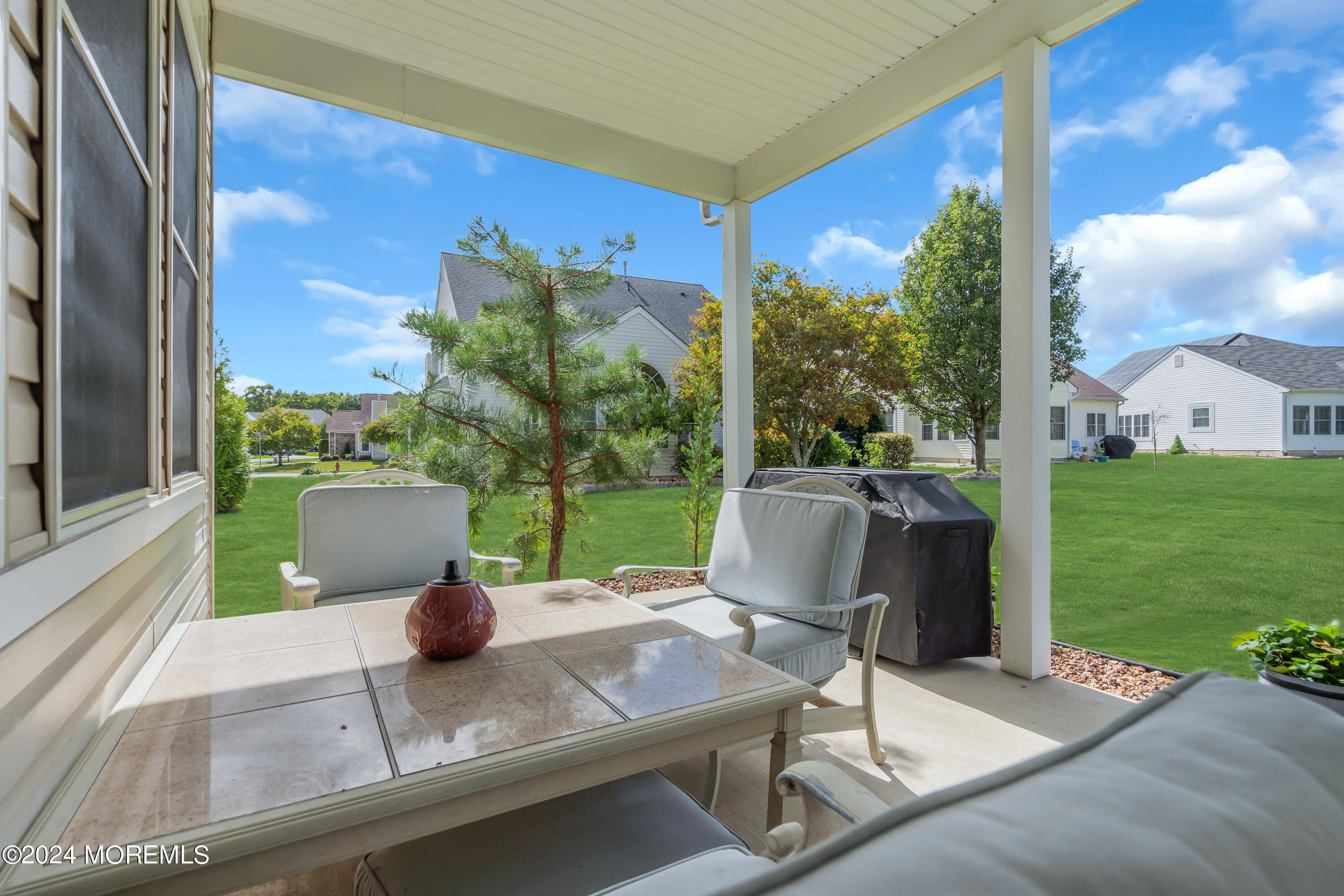49 Eagleswood Drive Waretown, NJ 08758 - Photo 48 of 51 a view of a patio with a table chairs and a table