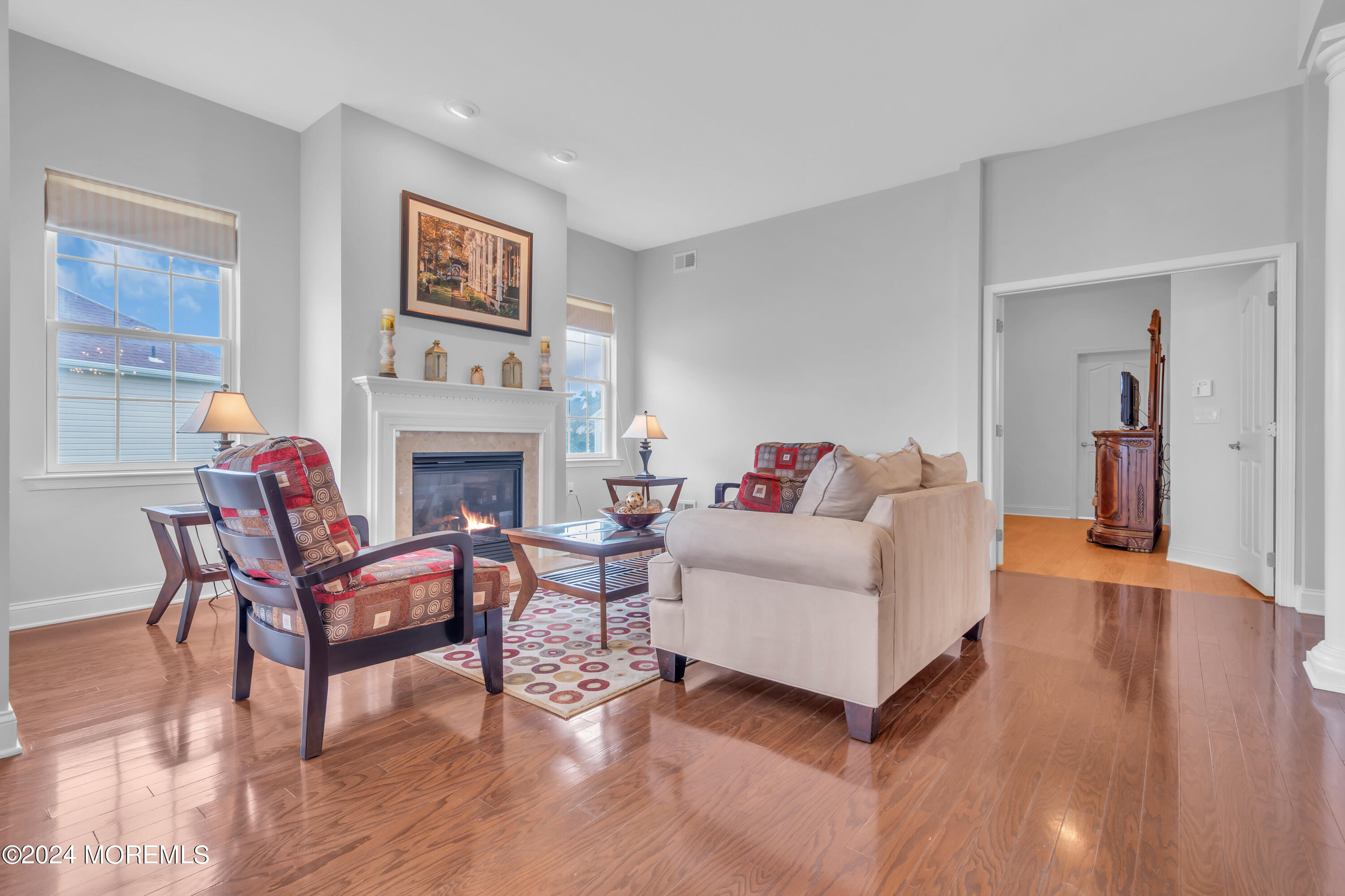 49 Eagleswood Drive Waretown, NJ 08758 - Photo 6 of 51 a living room with furniture a flat screen tv and a fireplace