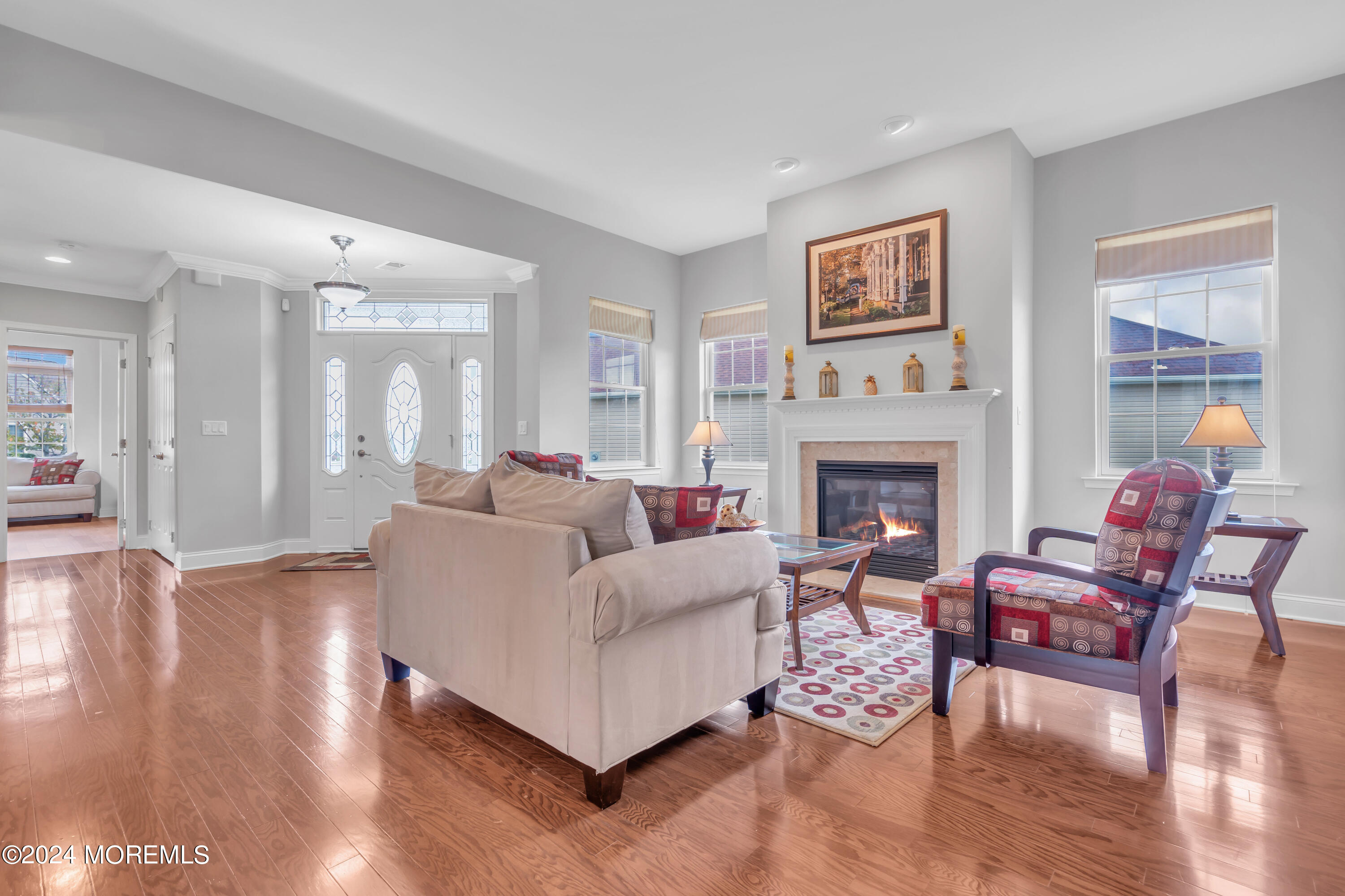 49 Eagleswood Drive Waretown, NJ 08758 - Photo 7 of 51 a living room with furniture a large window and a fireplace
