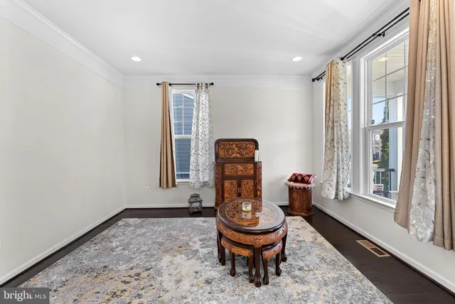 a view of a dining room with furniture a chandelier and wooden floor