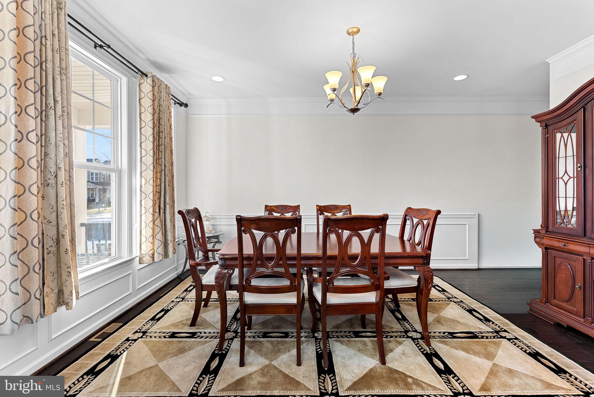 1010 Themis Street Southeast Leesburg, VA 20175 - Photo 15 of 64 a view of a dining room with furniture a chandelier and wooden floor