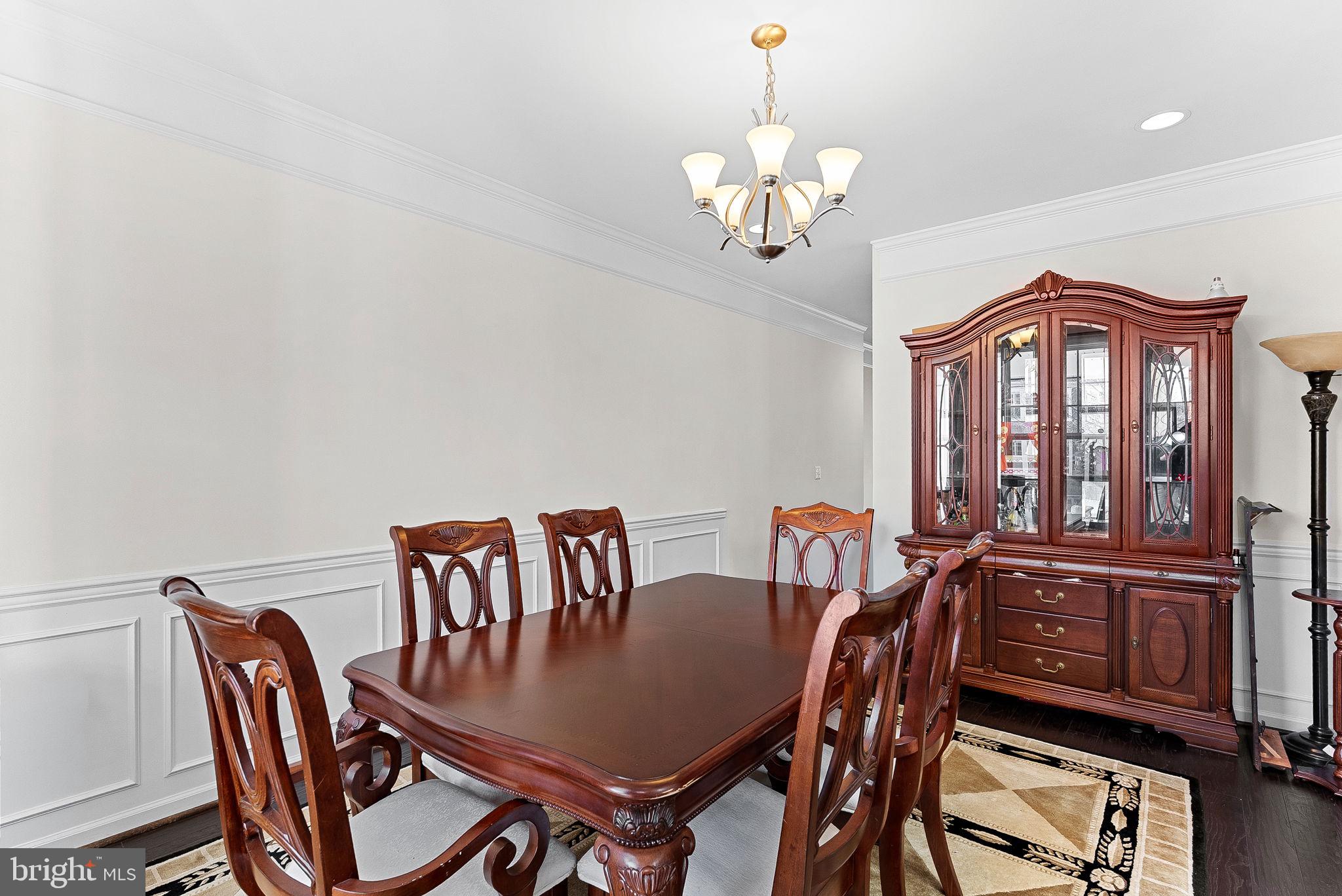 1010 Themis Street Southeast Leesburg, VA 20175 - Photo 16 of 64 a view of a dining room with furniture a chandelier and wooden floor