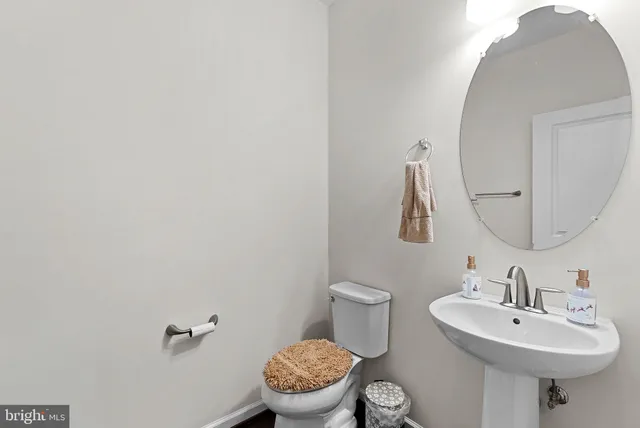 a bathroom with a granite countertop sink a toilet and shower
