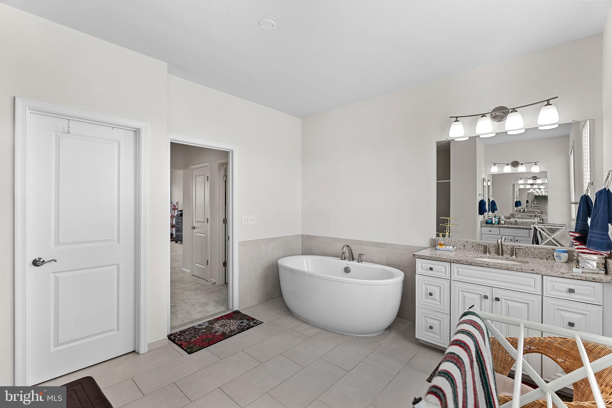 1010 Themis Street Southeast Leesburg, VA 20175 - Photo 34 of 64 a spacious bathroom with a bathtub and shower