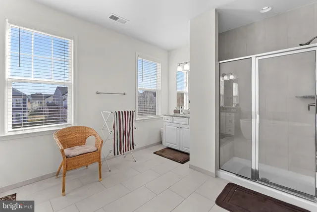a bathroom with a granite countertop sink toilet a mirror and shower