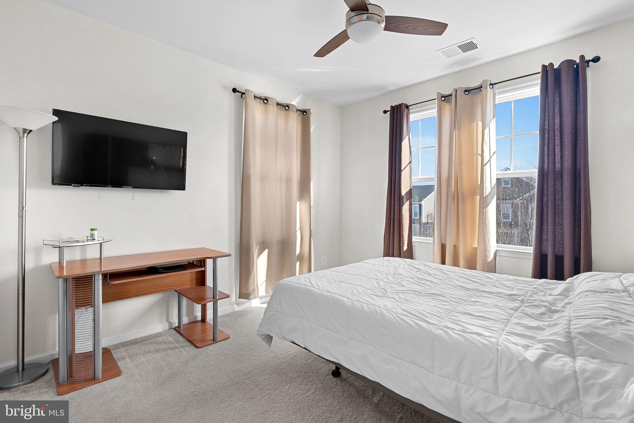 1010 Themis Street Southeast Leesburg, VA 20175 - Photo 40 of 64 a bedroom with a bed and a flat screen tv