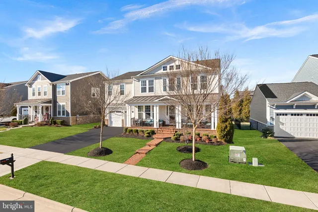 a front view of a house with a yard table and chairs