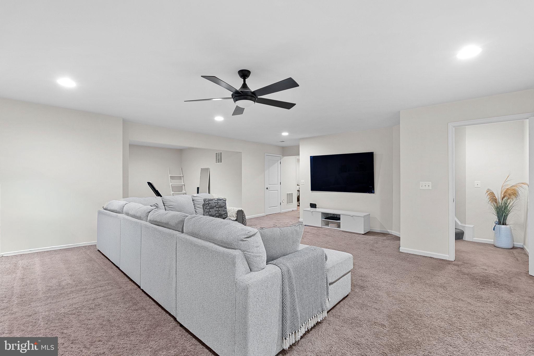 1010 Themis Street Southeast Leesburg, VA 20175 - Photo 50 of 64 a living room with furniture and a flat screen tv