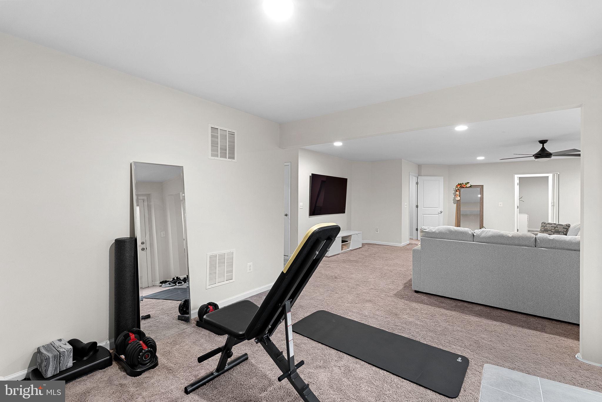 1010 Themis Street Southeast Leesburg, VA 20175 - Photo 52 of 64 a living room with furniture and a flat screen tv