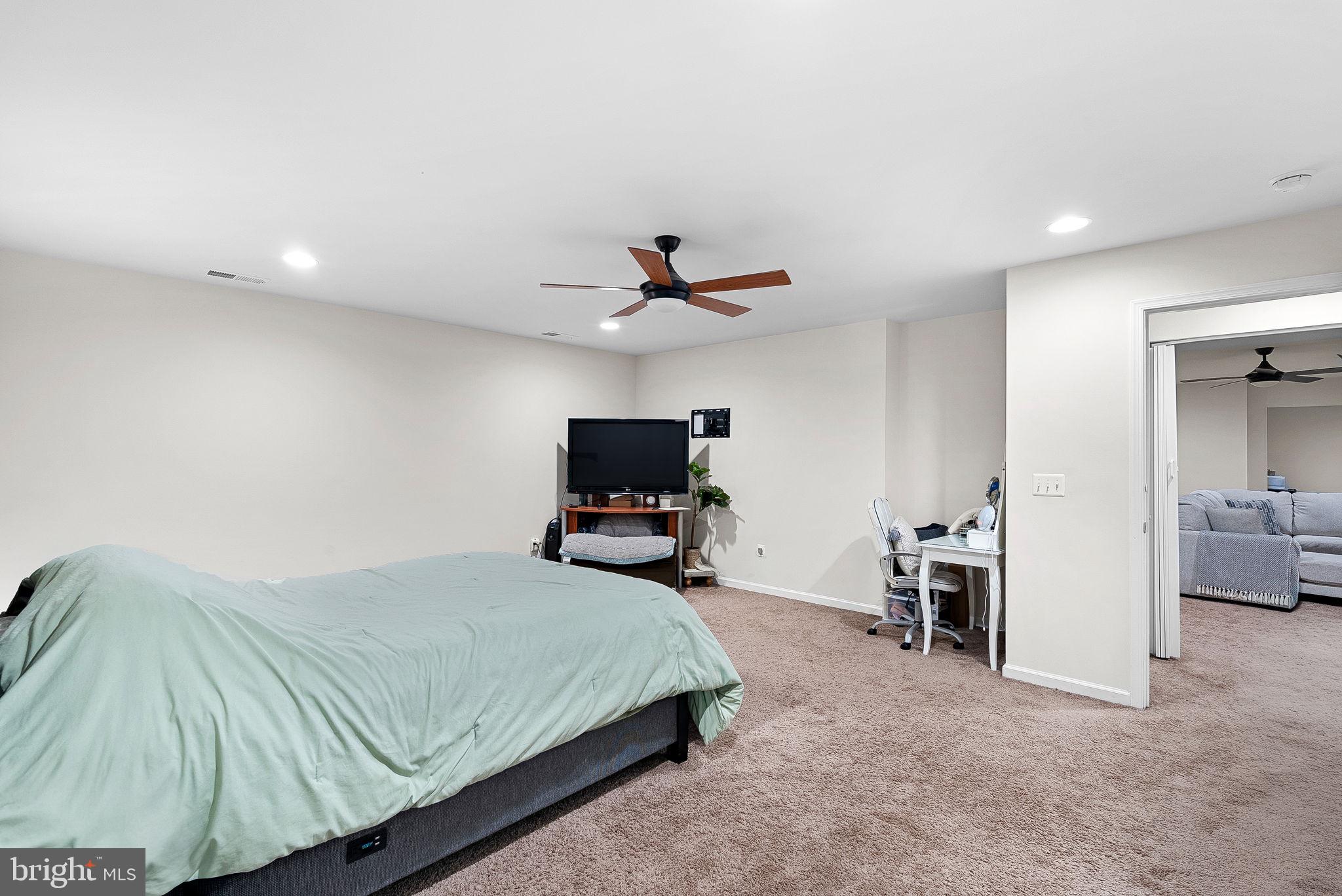 1010 Themis Street Southeast Leesburg, VA 20175 - Photo 54 of 64 a bedroom with a bed and a television