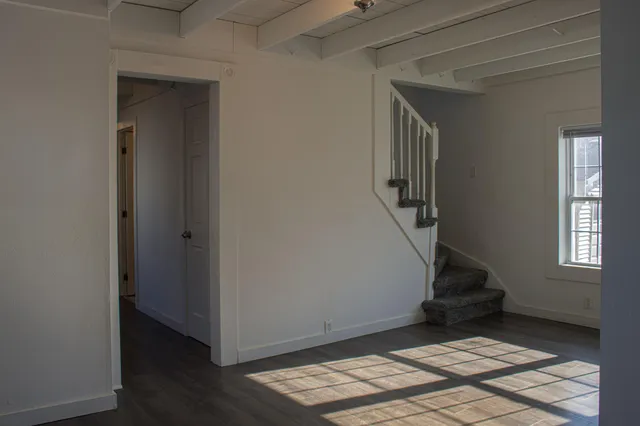 a view of entryway with wooden floor and stairs